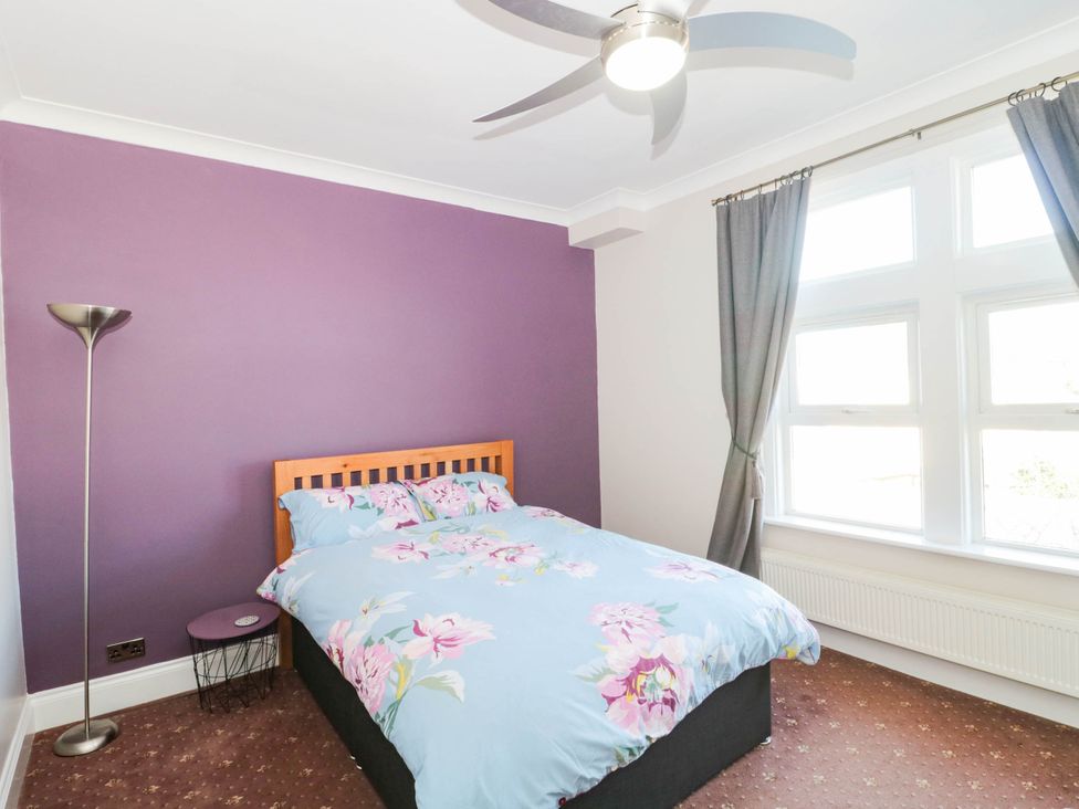 A bedroom with a bed and lamp at Ashbourne House 