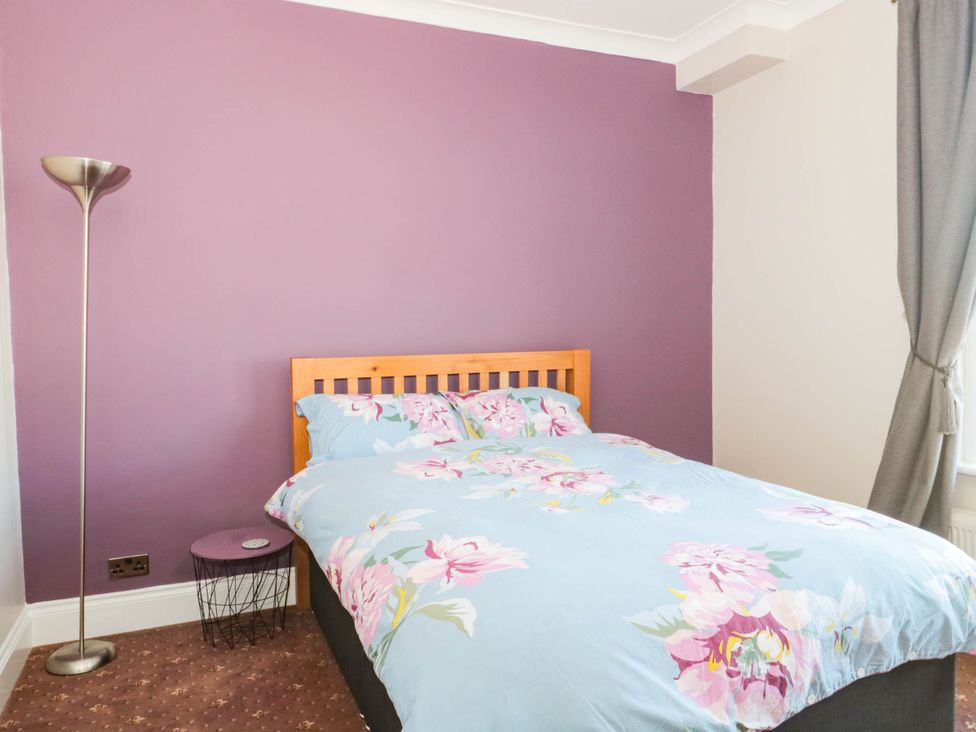 A bedroom with a bed and lamp at Ashbourne House