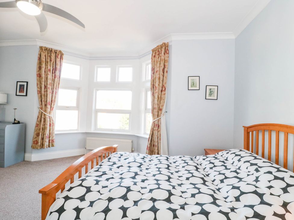 A bedroom with a bed and curtains at Ashbourne House