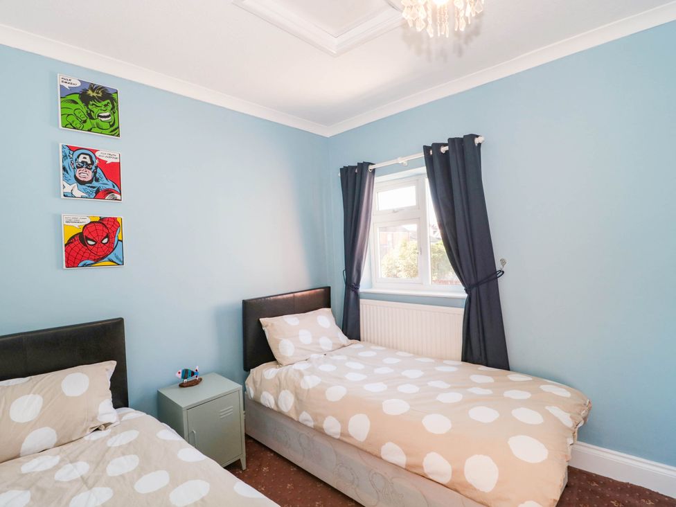 A bedroom with two beds and wall art at Ashbourne House in 