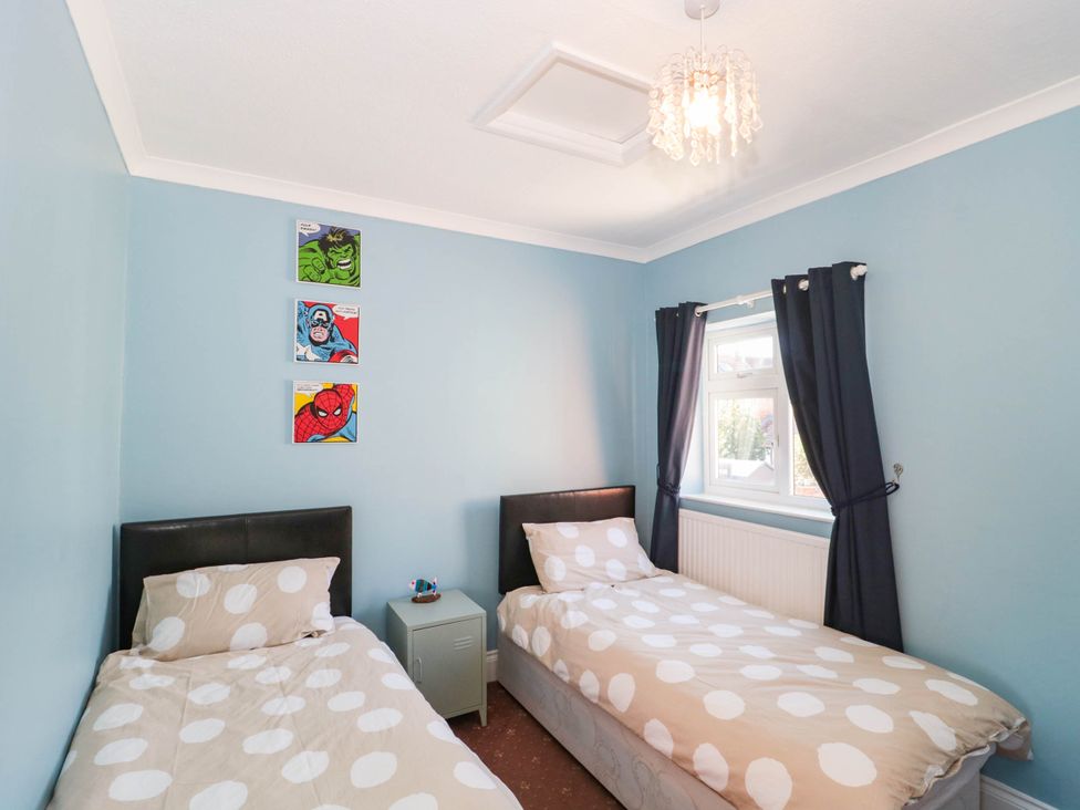 A bedroom with two beds and comic art at Ashbourne House