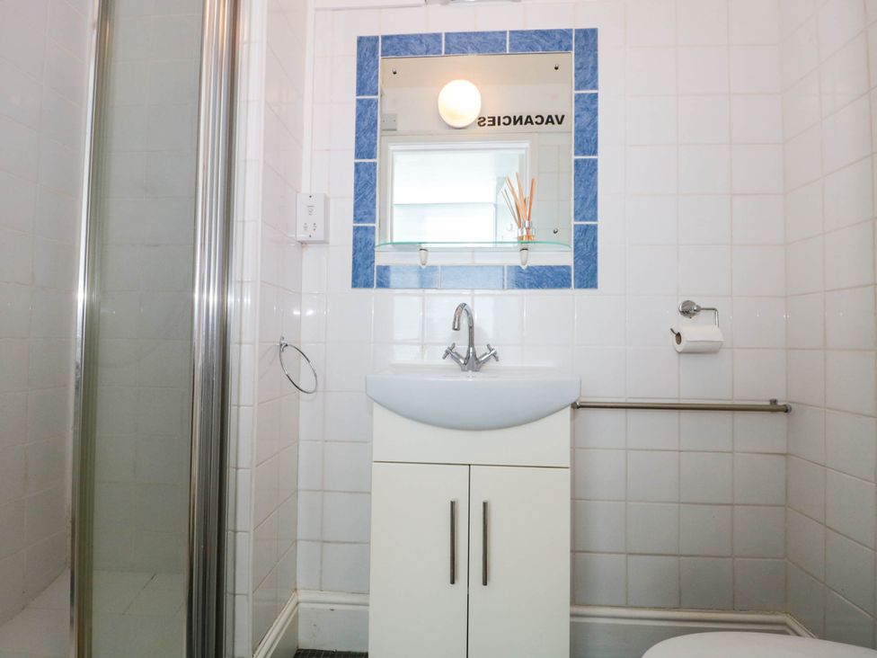 A bathroom with a shower, sink, and toilet at Ashbourne House 