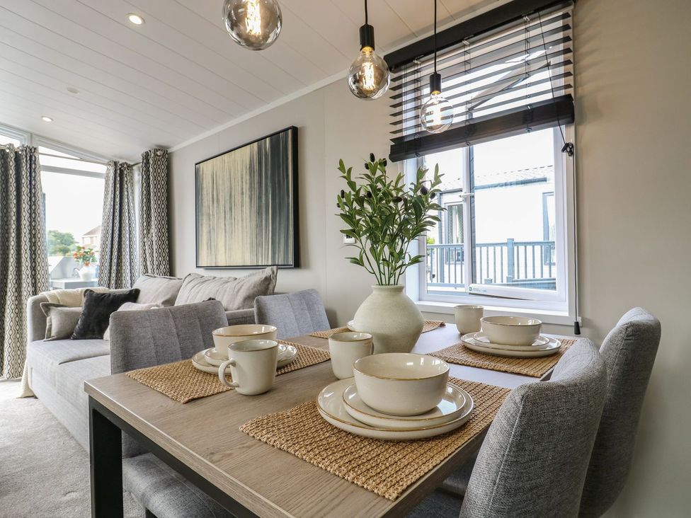 A dining area with a table and chairs at Lakewood Plot 7 Clacton-on-Sea