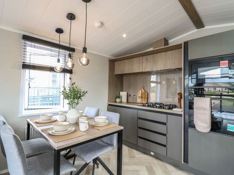 A kitchen with dining table and chairs at Lakewood Plot 7 Clacton-on-Sea