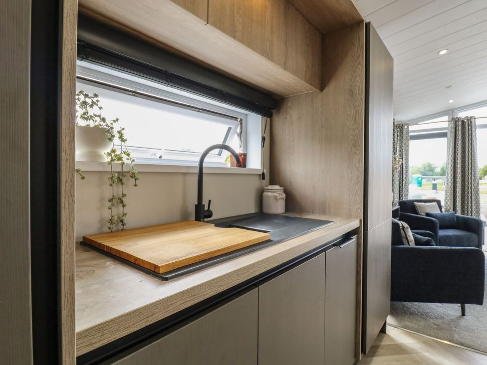 A kitchen with a sink and cutting board at Lakewood Plot 7 Clacton-on-Sea