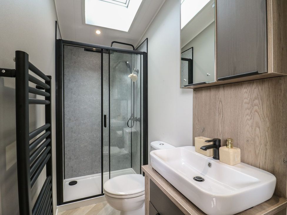 A bathroom with a shower, toilet, and sink at Lakewood Plot 7 in Clacton-on-Sea