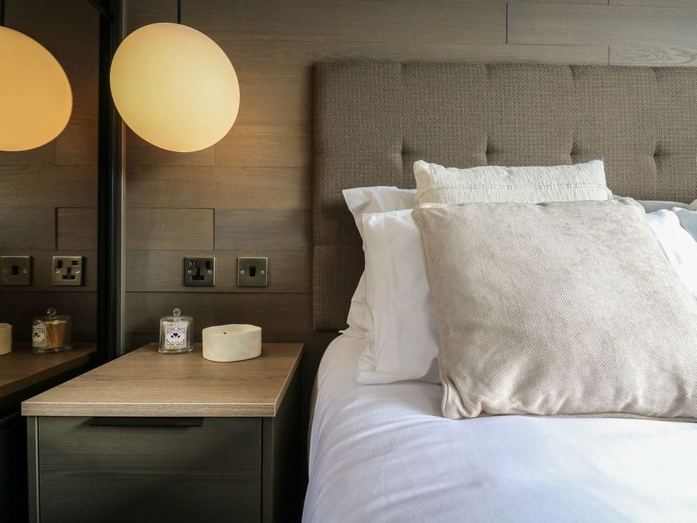 A bedroom with a bed and bedside table at Lakewood Plot 7, Clacton-on-Sea