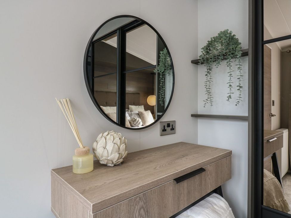 A bedroom with a mirror and shelf at Lakewood Plot 7 Clacton-on-Sea
