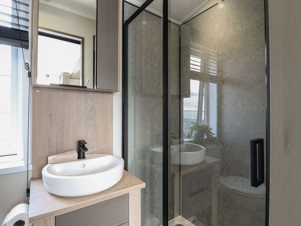 A bathroom with a sink and shower at Lakewood Plot 7 in Clacton-on-Sea