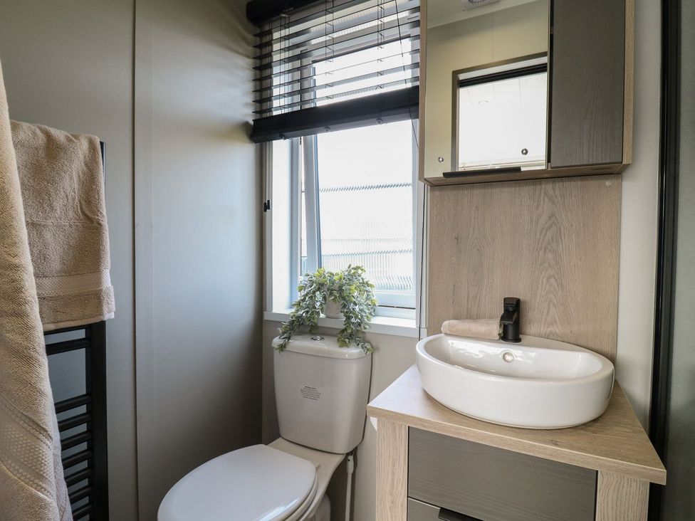 A bathroom with a sink and toilet at Lakewood Plot 7 in Clacton-on-Sea