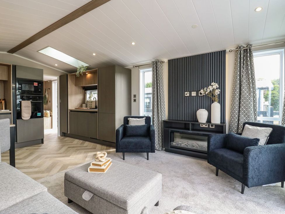 A living room with a sofa and chairs at Lakewood Plot 8