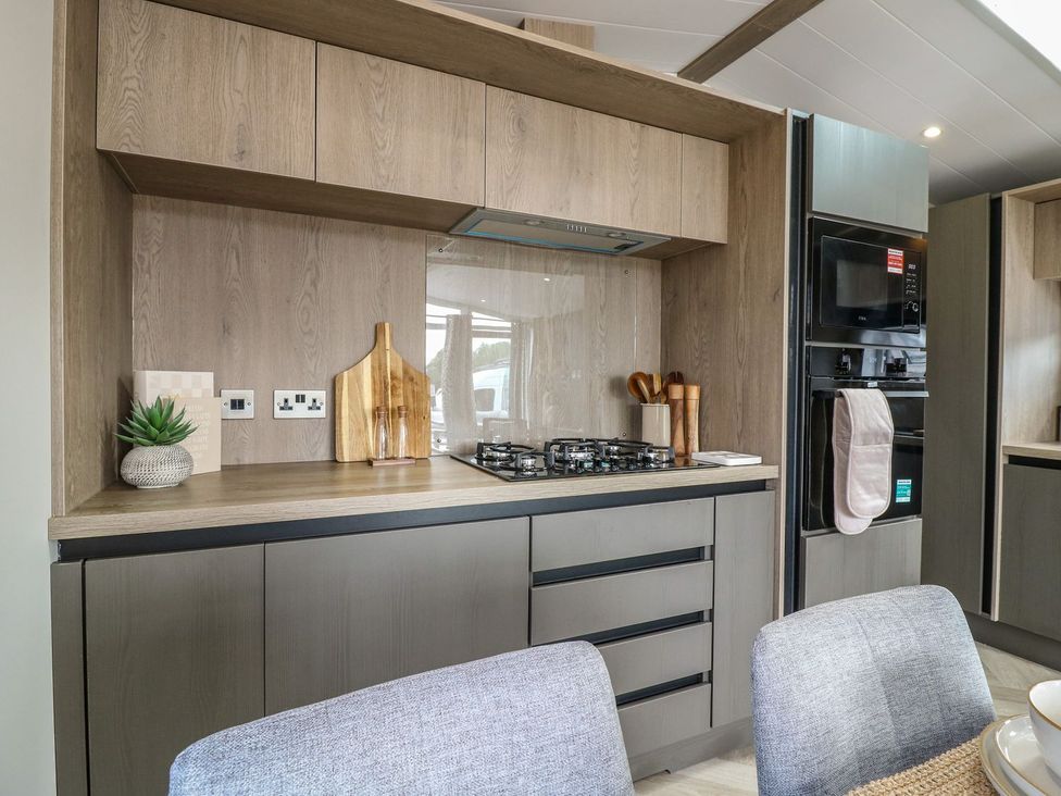A kitchen with cabinets and appliances at Lakewood Plot 9 in Clacton-on-Sea