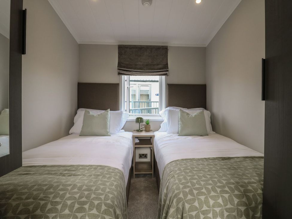 A bedroom with two beds and a window at Lakewood Plot 9 Clacton-on-Sea