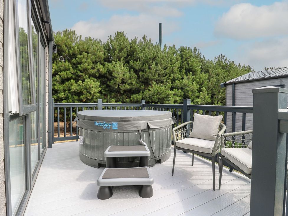 An outdoor space with a hot tub and seating at Lakewood Plot 9 in Clacton-on-Sea
