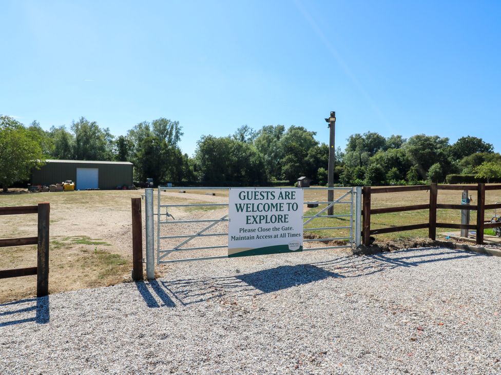 An outdoor area with a gate and sign at Lakewood Plot 9 in St. Osyth