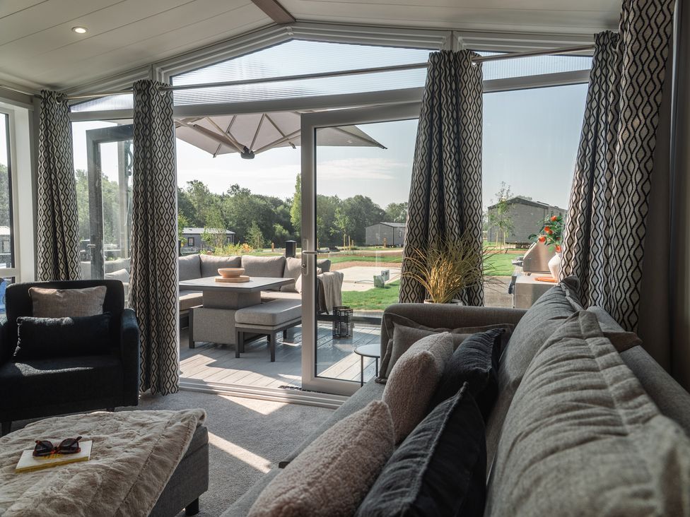 A living room with a view to the outside at Lakewood Plot 9 in St. Osyth