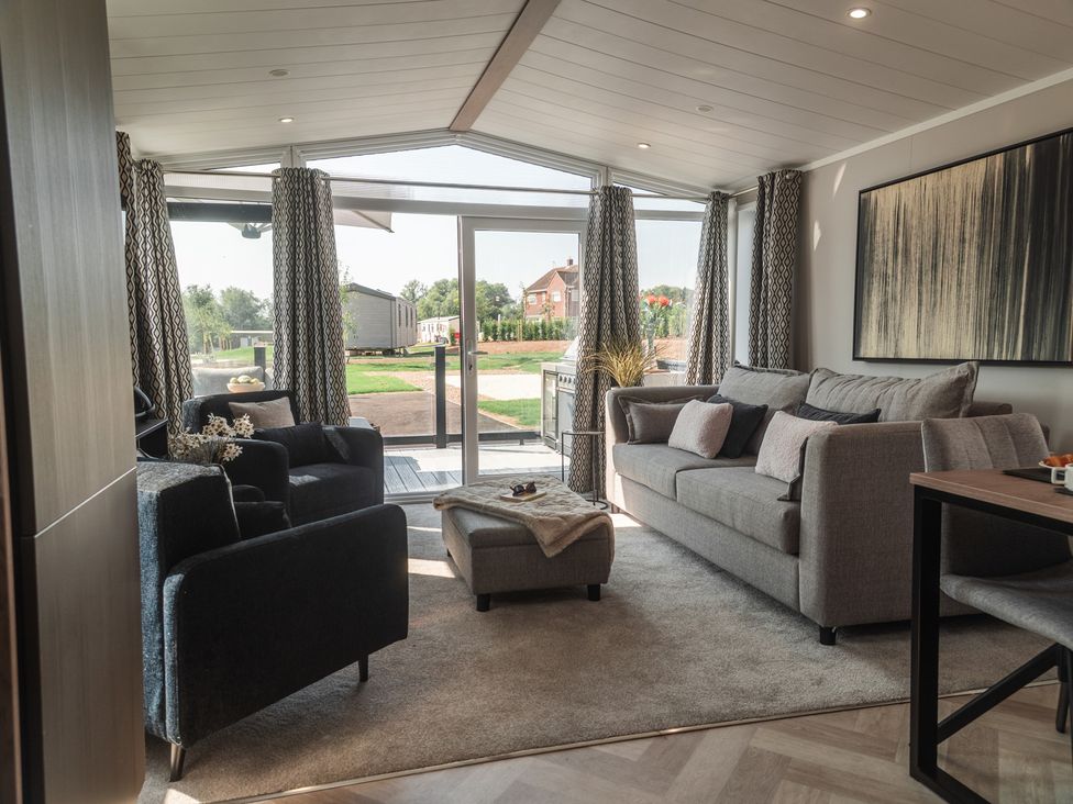 A living room with a sofa and armchairs at Lakewood Plot 9 St. Osyth
