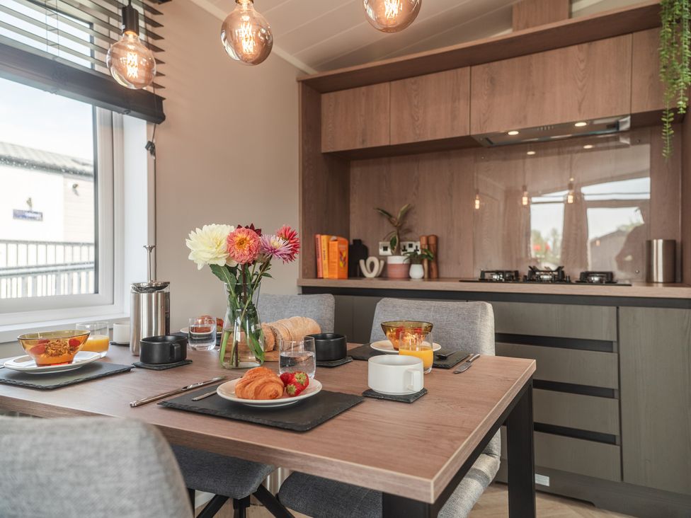 A dining room with a table set for breakfast at Lakewood Plot 9 St. Osyth