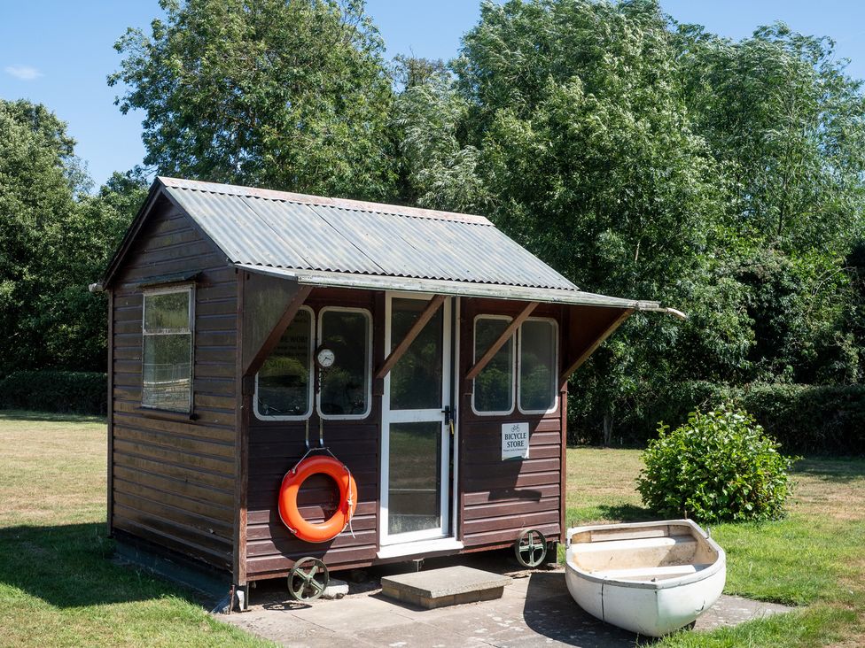 A shed with a life buoy and small boat at Lakewood Plot 9 St. Osyth