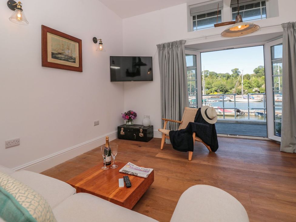 A living room with a sofa and armchair at Shipwrights in Brixham