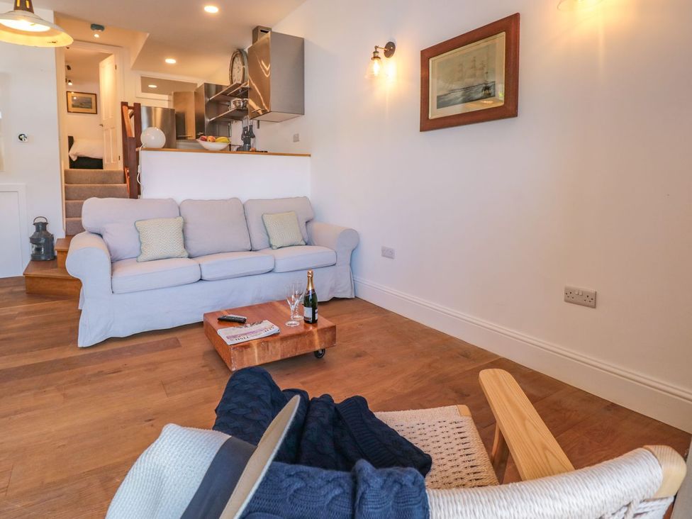 A living room with a sofa and coffee table at Shipwrights in Brixham