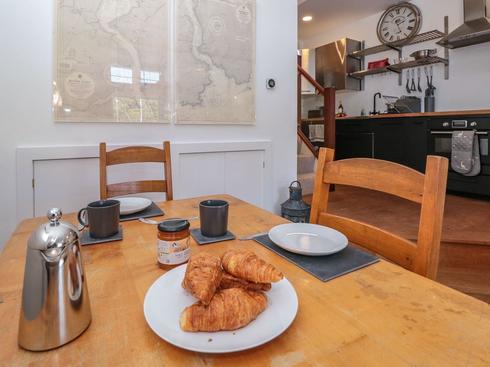 A dining room with a table set for breakfast at Shipwrights in Brixham