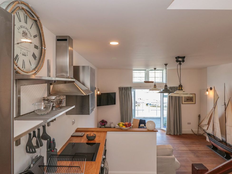 A kitchen with modern appliances and a view at Shipwrights in Brixham
