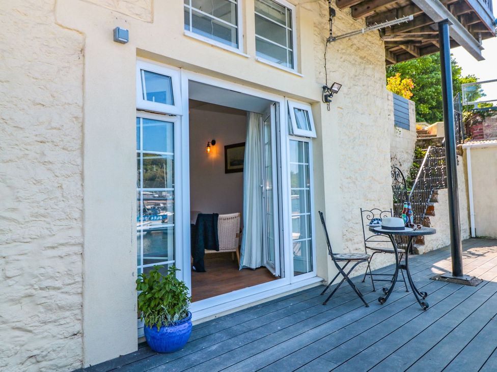 An outdoor seating area with table and chairs at Shipwrights in Brixham