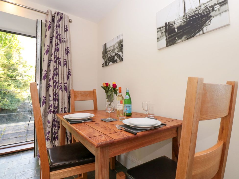 A dining room with a table set for two at the Spanish Boathouse in Brixham