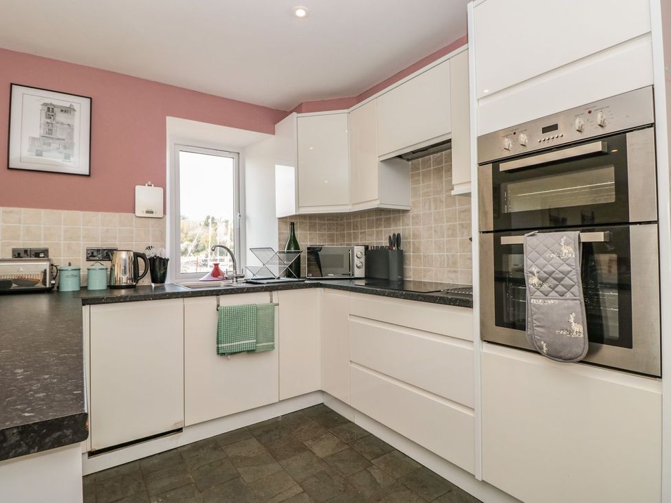A kitchen with modern appliances at Spanish Boathouse in Brixham