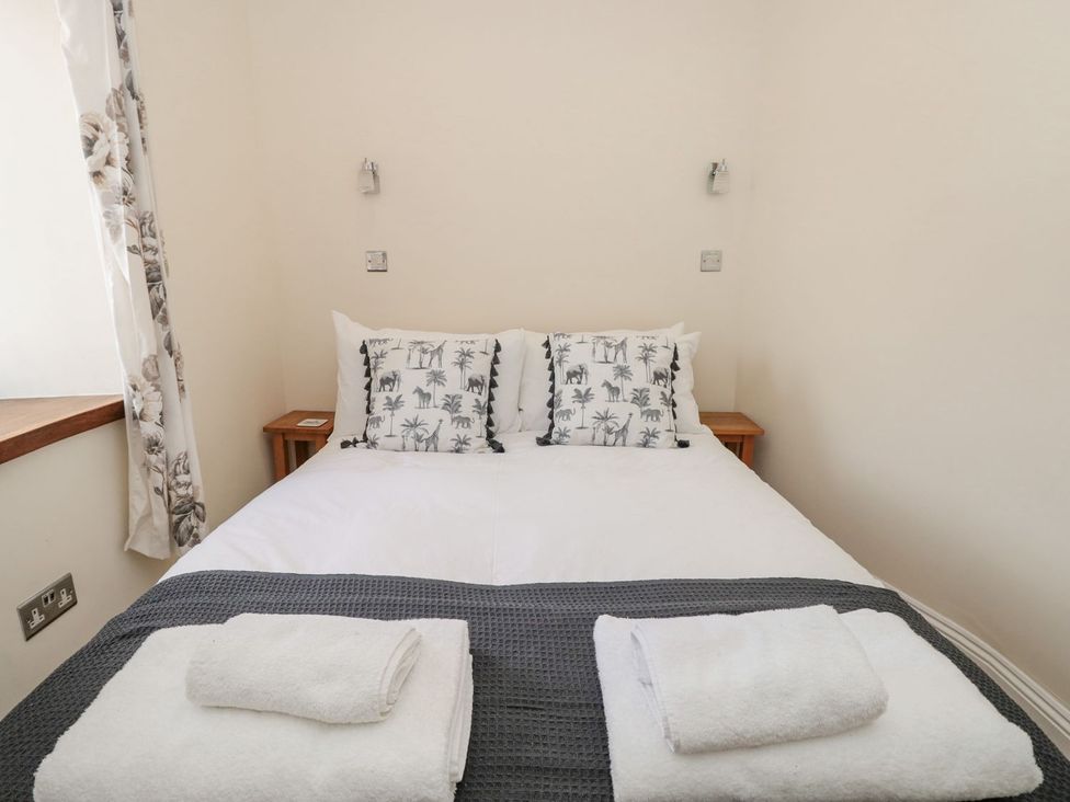 A bedroom with a bed and pillows at Spanish Boathouse in Brixham