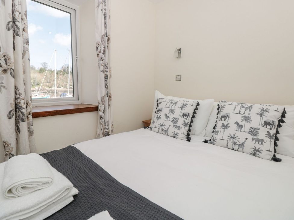 A bedroom with a bed and pillows at Spanish Boathouse in Brixham