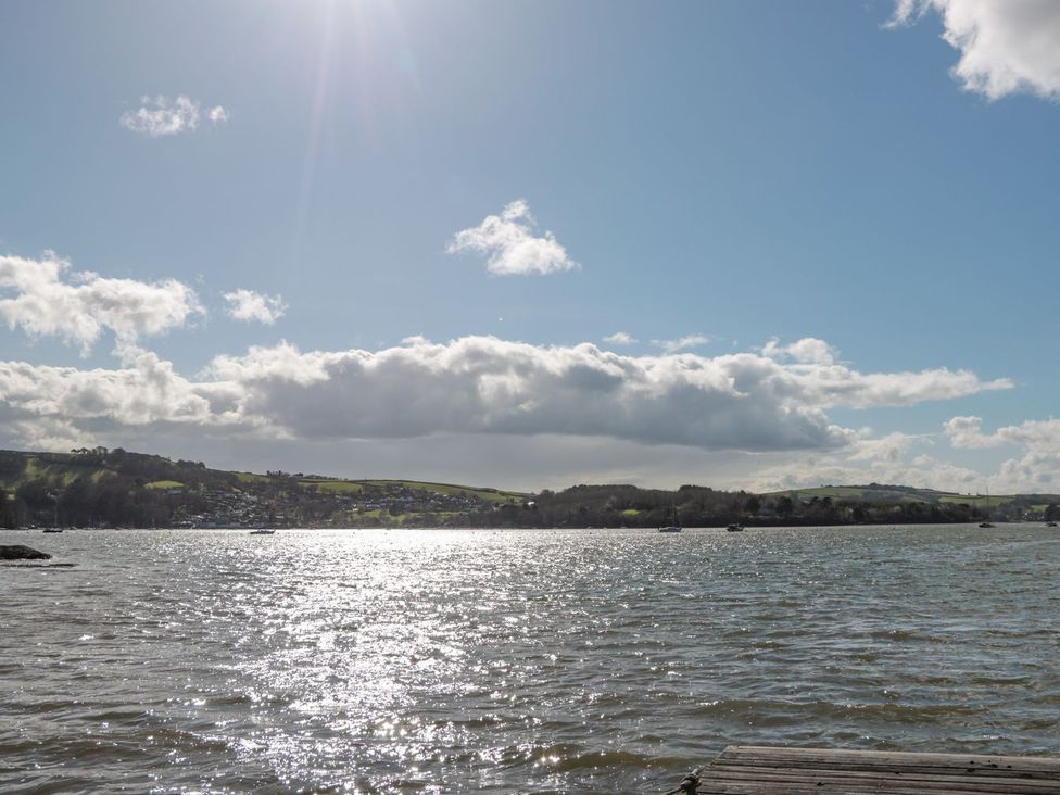 A view of water with boats and hills in the background at Spanish Boathouse in Brixham