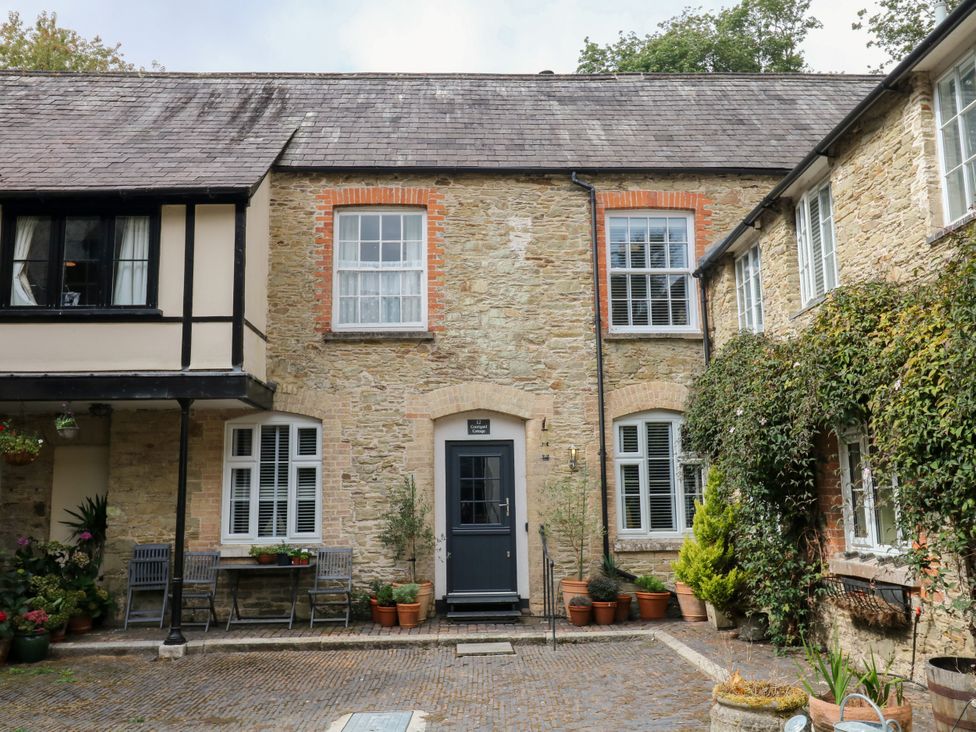 An outdoor area with plants and a door at 12 Courtyard Cottage at Sheplegh Court in Totnes