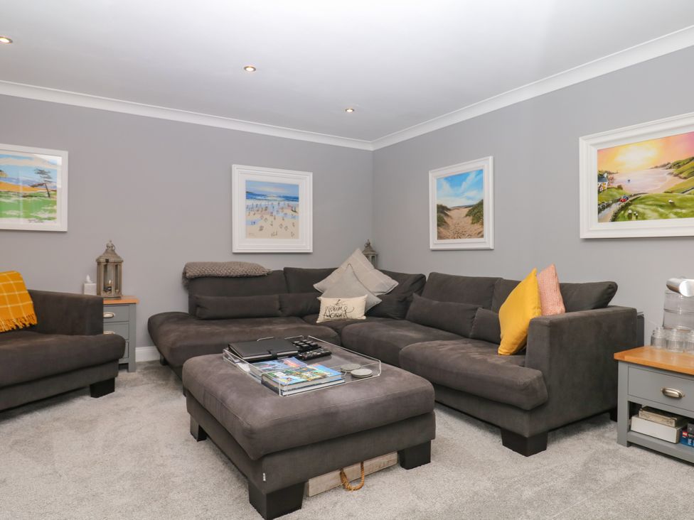 A living room with a sofa and armchair at 12 Courtyard Cottage at Sheplegh Court in Totnes