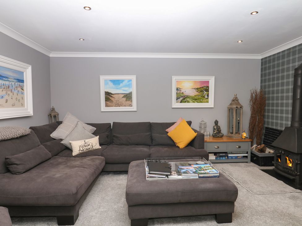 A living room with a sofa and coffee table at 12 Courtyard Cottage at Sheplegh Court in Totnes