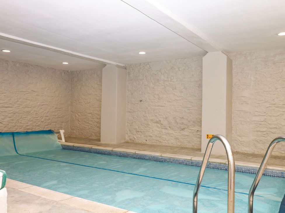 An indoor pool with a cover and steps at 12 Courtyard Cottage at Sheplegh Court, Totnes