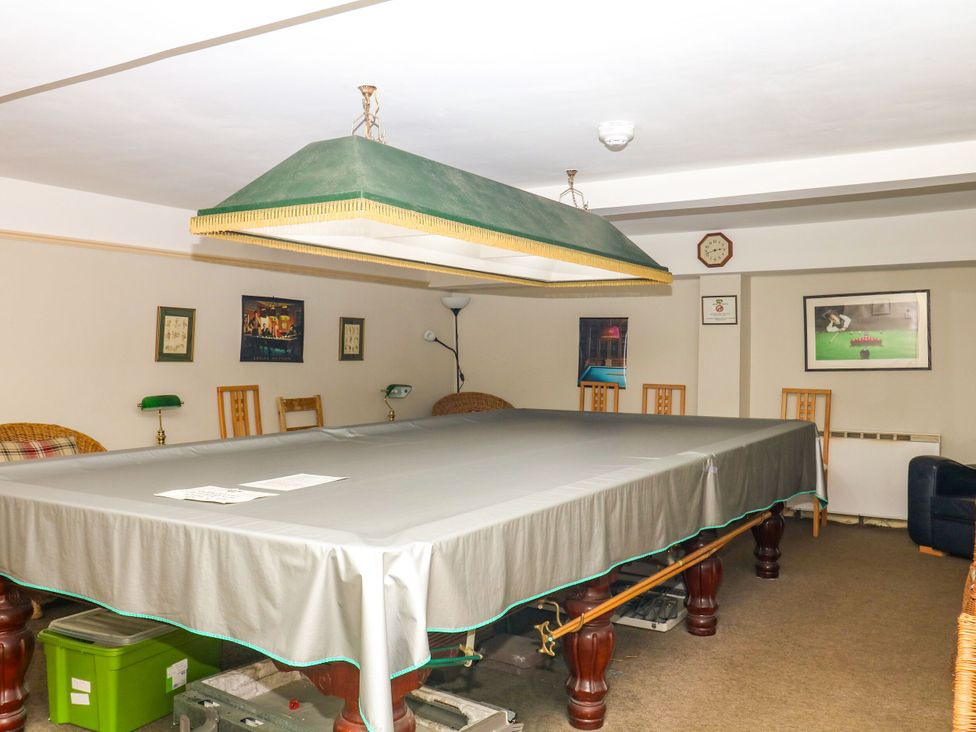 A snug with a billiard table and chairs at 12 Courtyard Cottage at Sheplegh Court Totnes