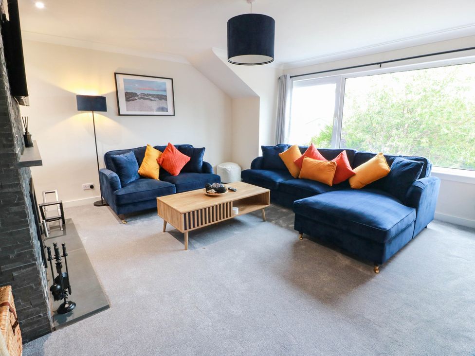 A living room with sofas and a coffee table at Camusfearna in Dalbeattie