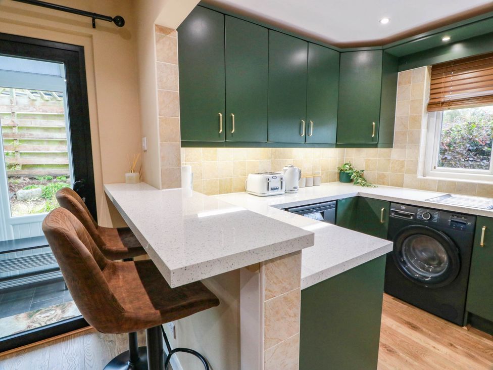 A kitchen with modern cabinets and appliances at Camusfearna in Dalbeattie