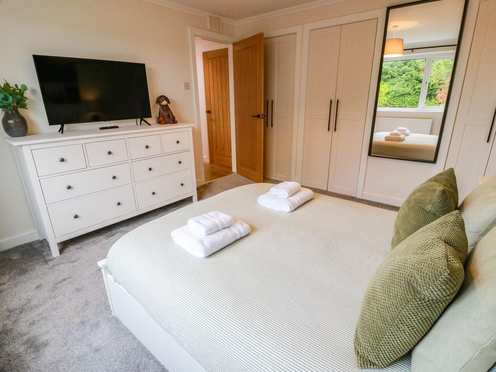 A bedroom with a bed and television at Camusfearna in Dalbeattie