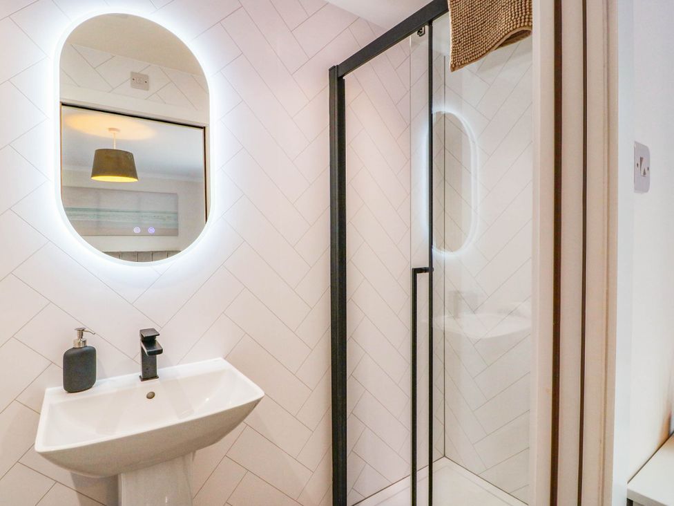 A bathroom with a sink and shower at Camusfearna in Dalbeattie