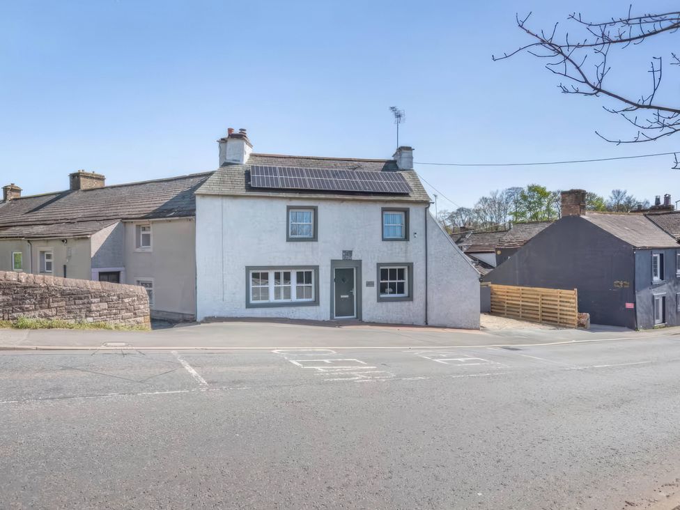 A house featuring solar panels and windows at The Quirky Cottage near Eamont Bridge