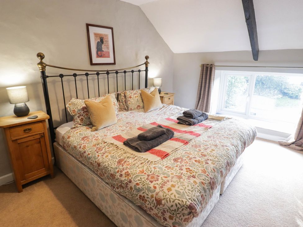 A bedroom with a bed and bedside table at Ty'r Wennol Fishguard