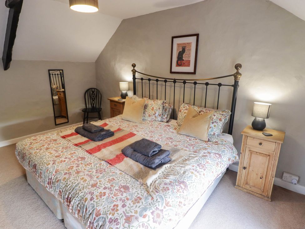 A bedroom with a double bed and bedside table at Ty'r Wennol Fishguard
