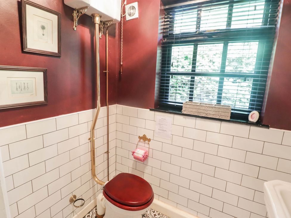 A bathroom with a toilet and window at Ty'r Wennol in Fishguard