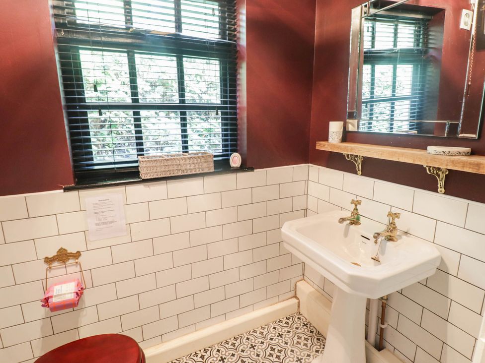 A bathroom with a sink and mirror at Ty'r Wennol in Fishguard
