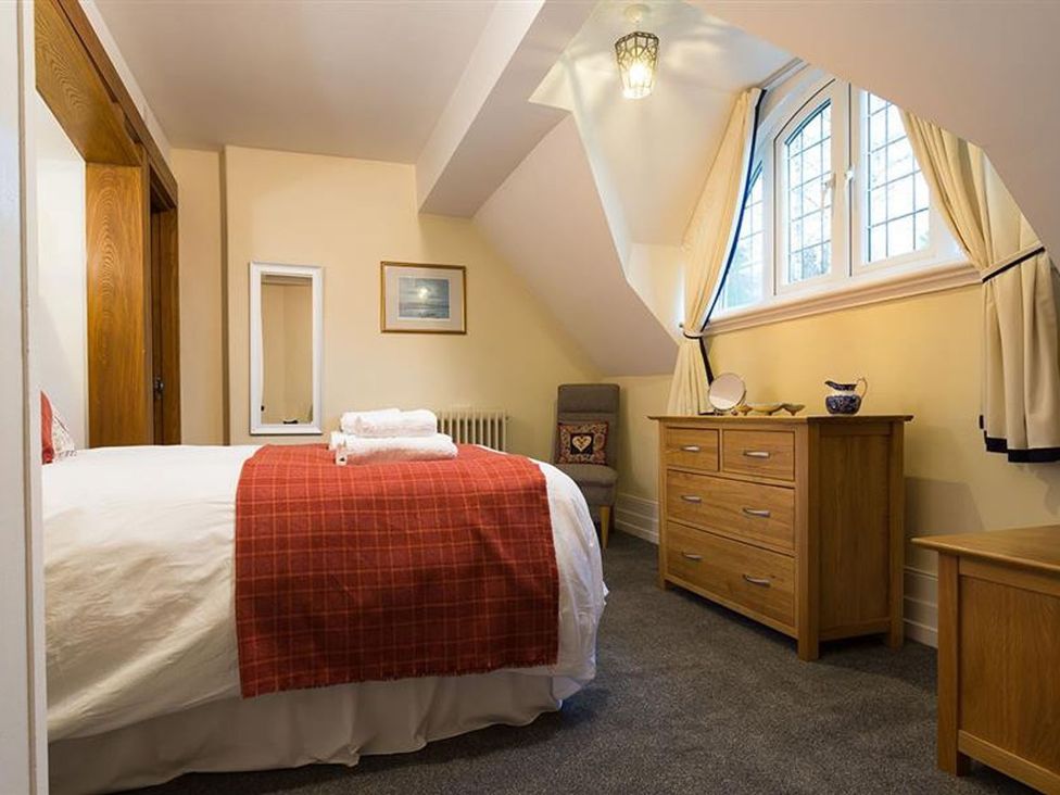 A bedroom with a bed and a drawer unit at White Gables in Ambleside