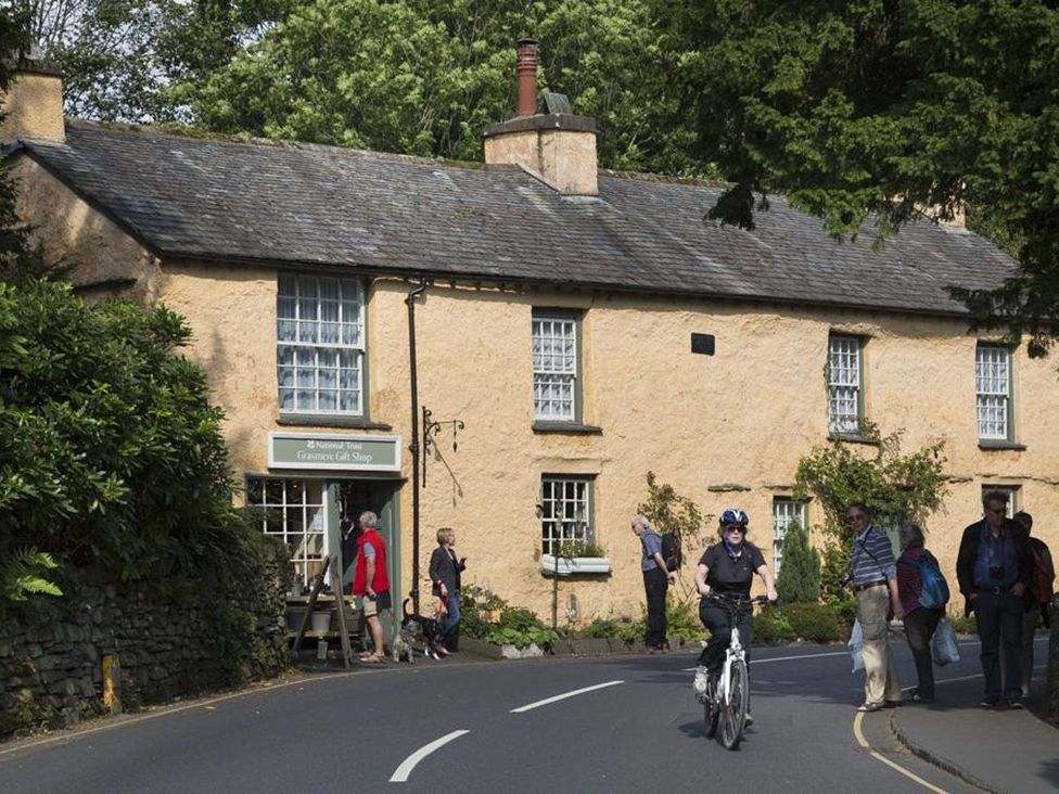 A cottage with a gift shop and people outside at White Gables in Ambleside