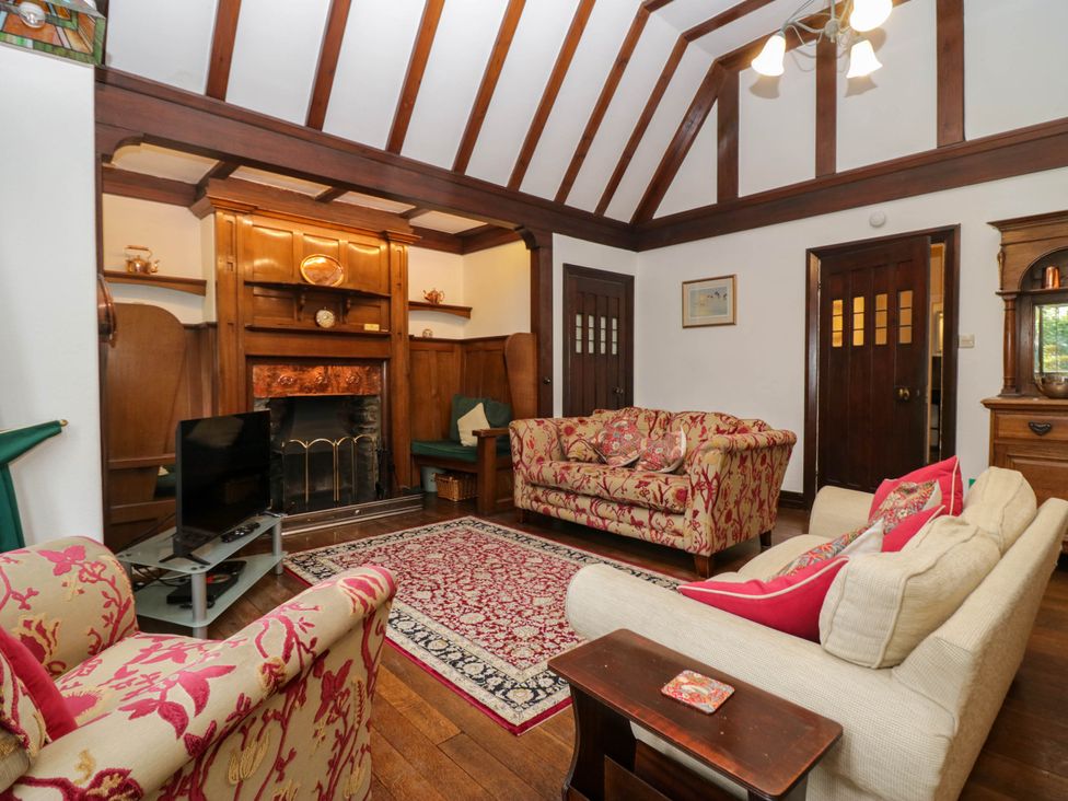A living room with sofas and a fireplace at White Gables in Grasmere